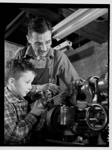 Father And Son Working On Machinery